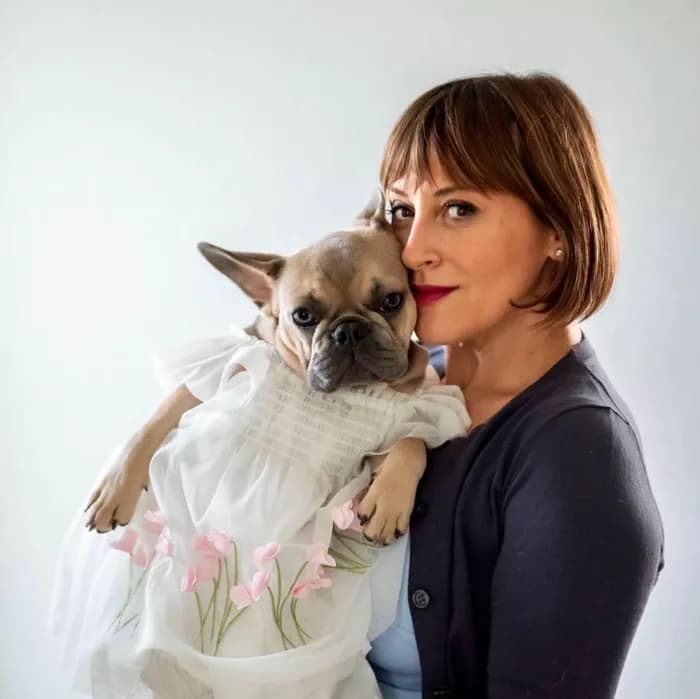 Marilo holding her dog at the salon