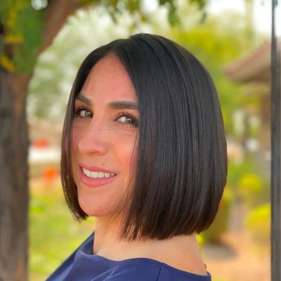 Sleek chin-length dark brown bob haircut with glossy finish at Salon Lola in Gilbert, Arizona