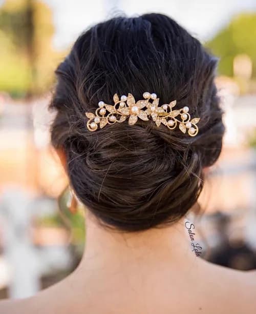 Elegant bridal up-do with a gold hairpiece