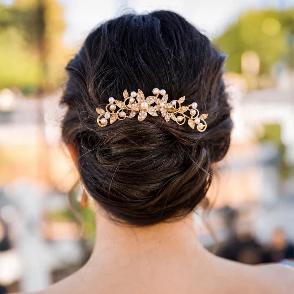Elegant bridal updo with gold pearl hairpiece styled for wedding at Salon Lola in Gilbert, Arizona